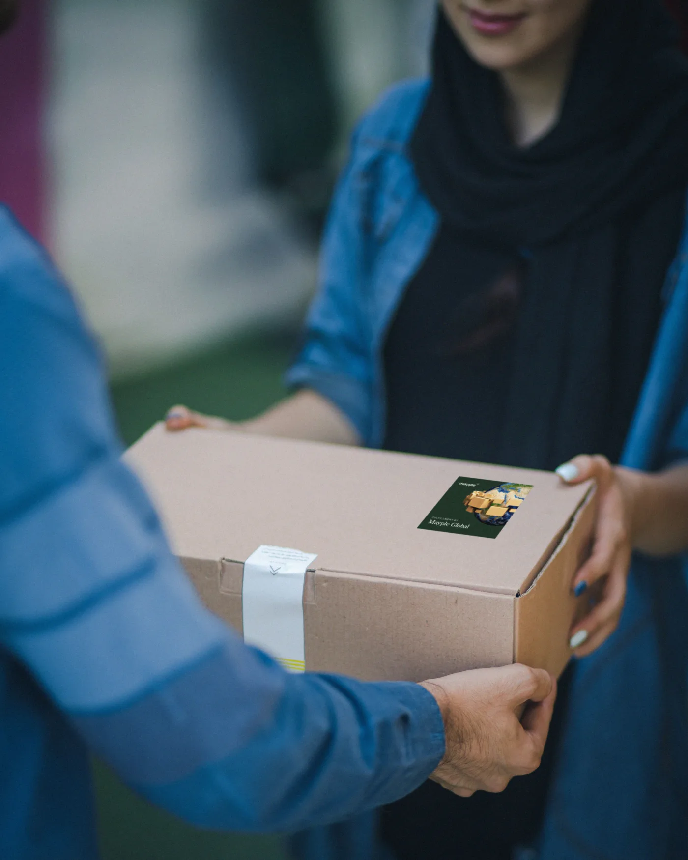 A Mayple Global package handed to a customer
